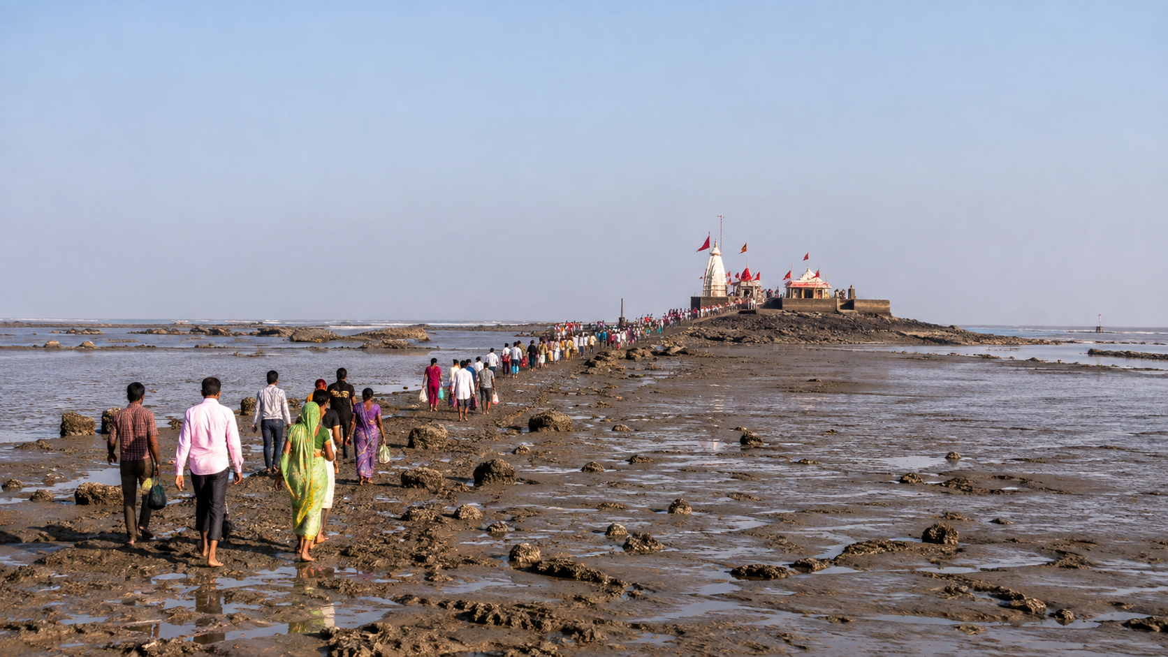 Pilgrims walking across the exposed tidal path to Nishkalank Mahadev at Koliyak